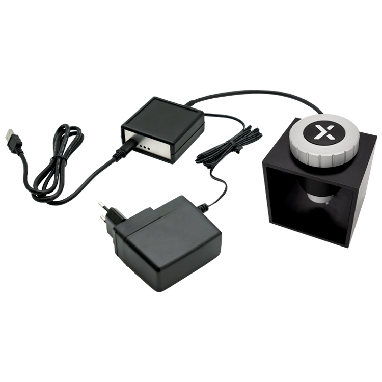 The image shows a fully wired HAPTICORE Eval Kit setup consisting of a HAPTICORE rotary haptic actuator in the Eval Kit metal stand connected to the Control Unit Pro with a 6-pin adapter cable. A 12 V power supply is also connected to the Control Unit Pro. The Control Unit is finally connected to the PC via USB-C to USB-A cable.