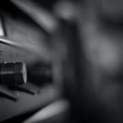 Black and white image of a closeup shot of a radio where the focus is on the rotary knob.